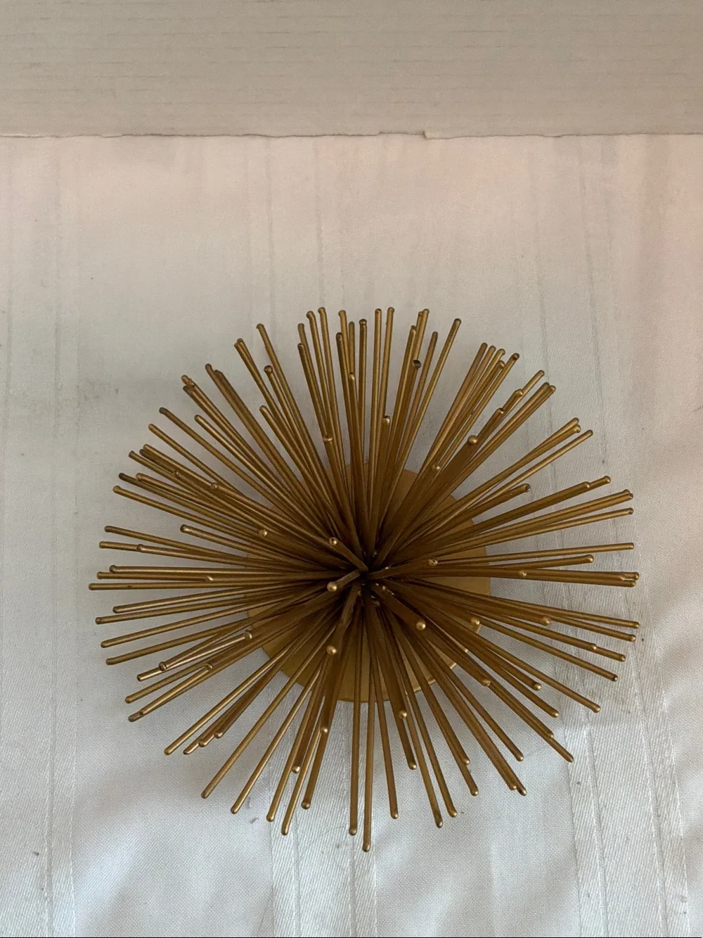 Gold tone metal atomic starburst or sea urchin wall art